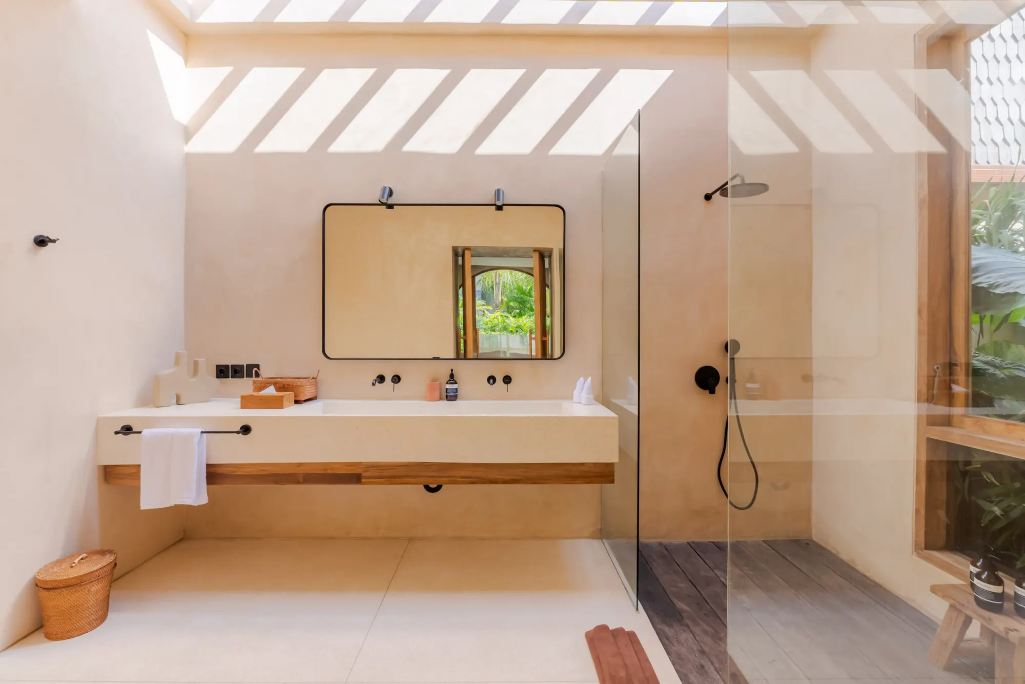 Modern bathroom with natural light, dual vanity and rainfall shower