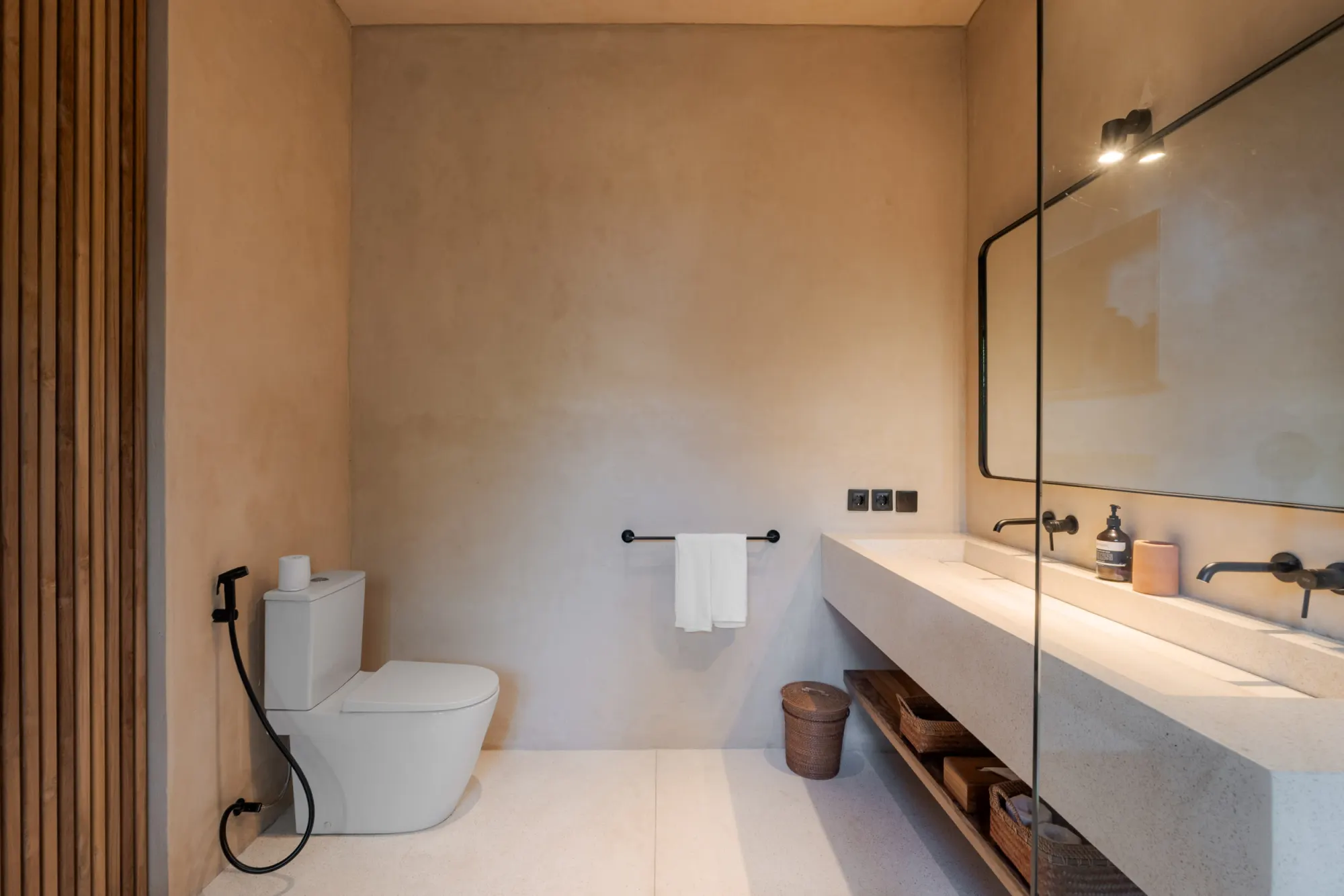 Contemporary bathroom with concrete sink and woven accessories