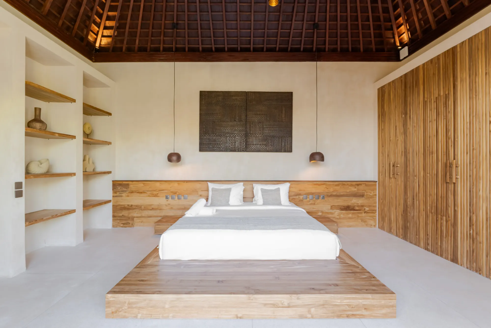 Bedroom suite with wood accents and dual beds with shelving