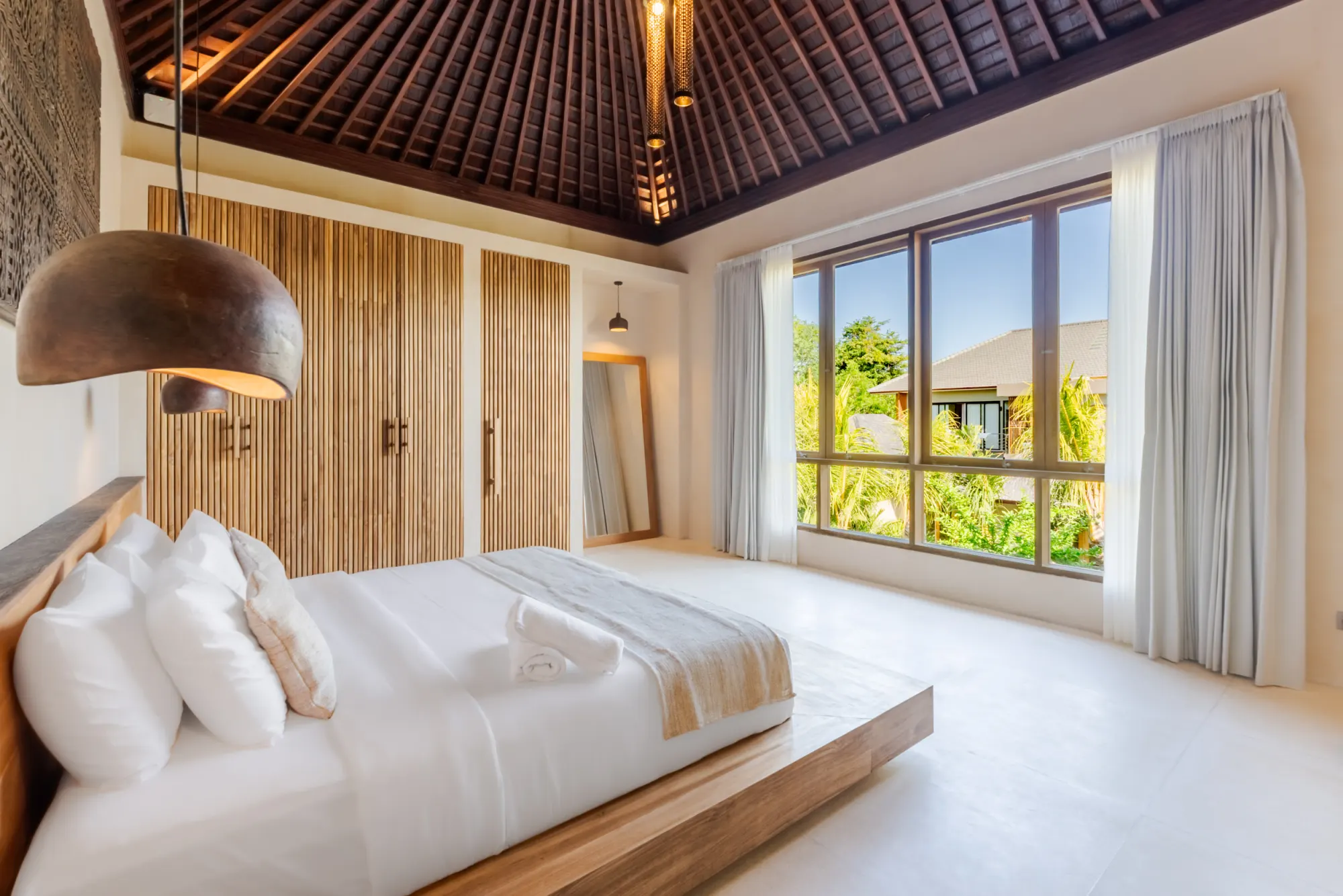 Twin-bed bedroom with woven decorative wall hangings