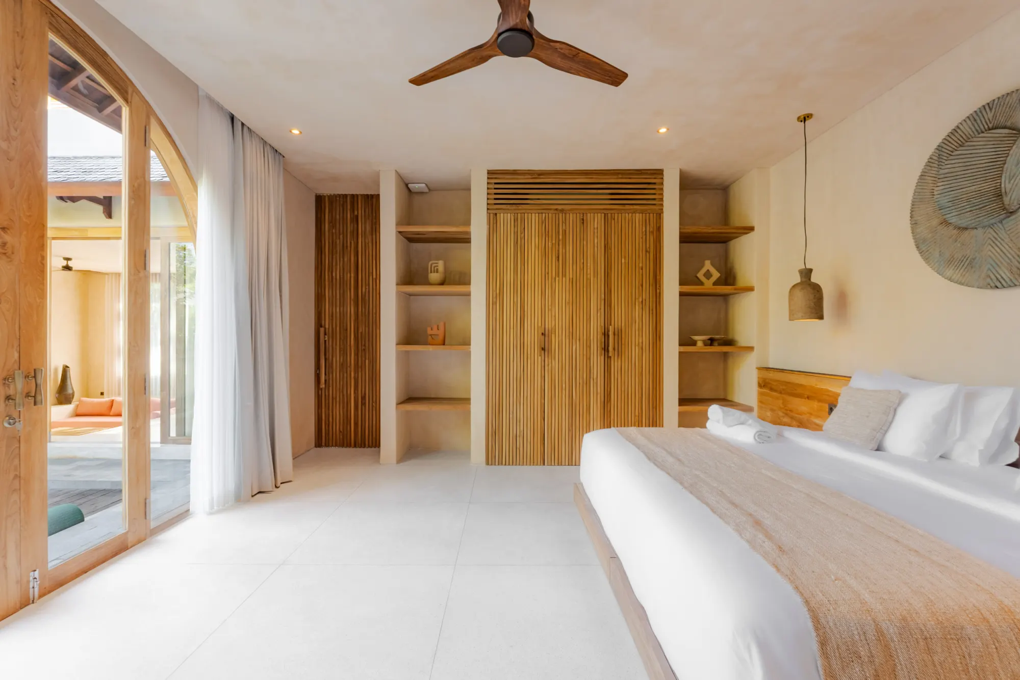 Master bedroom with pool view through garden-facing doors
