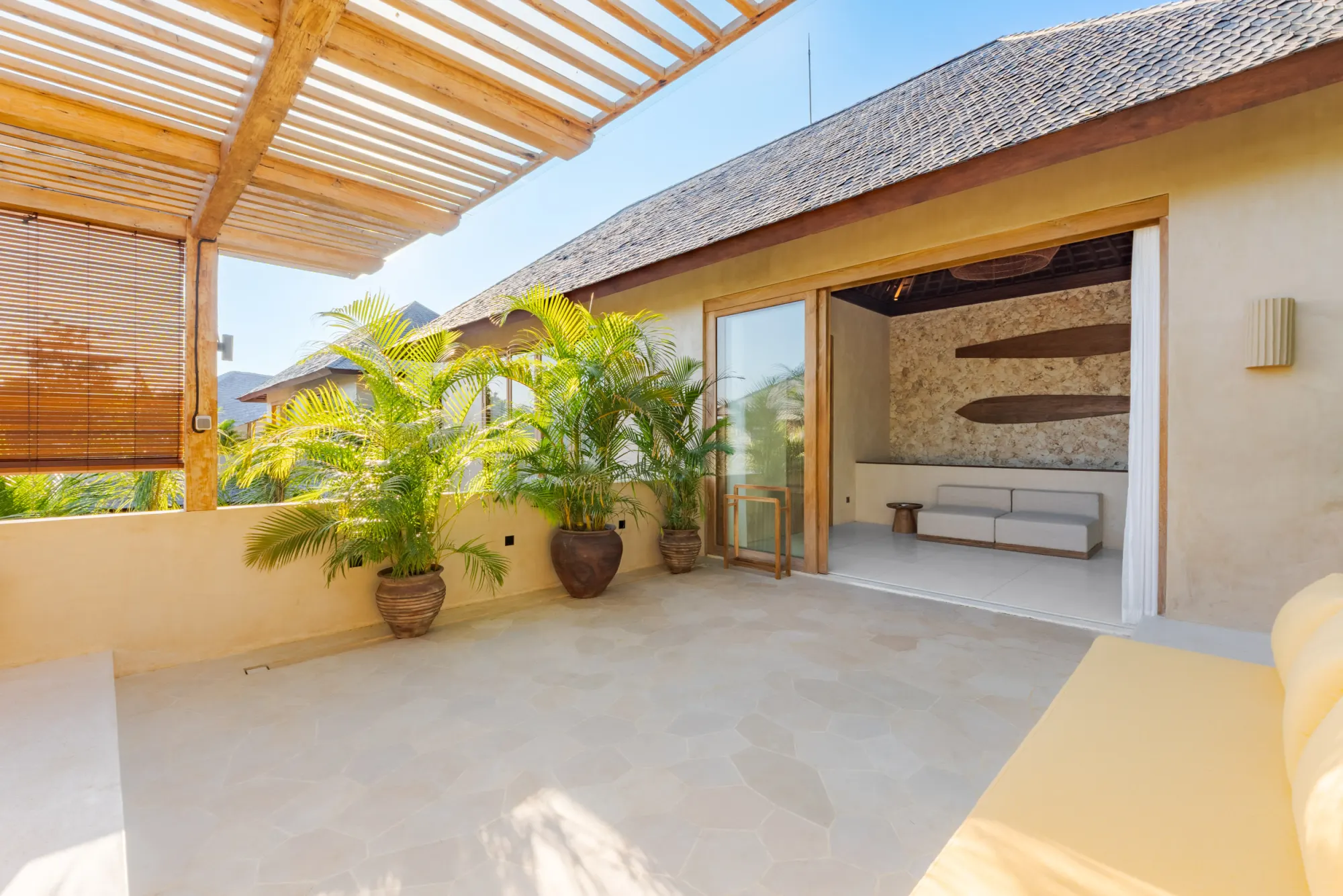 Bedroom with open doors revealing garden and spa basin