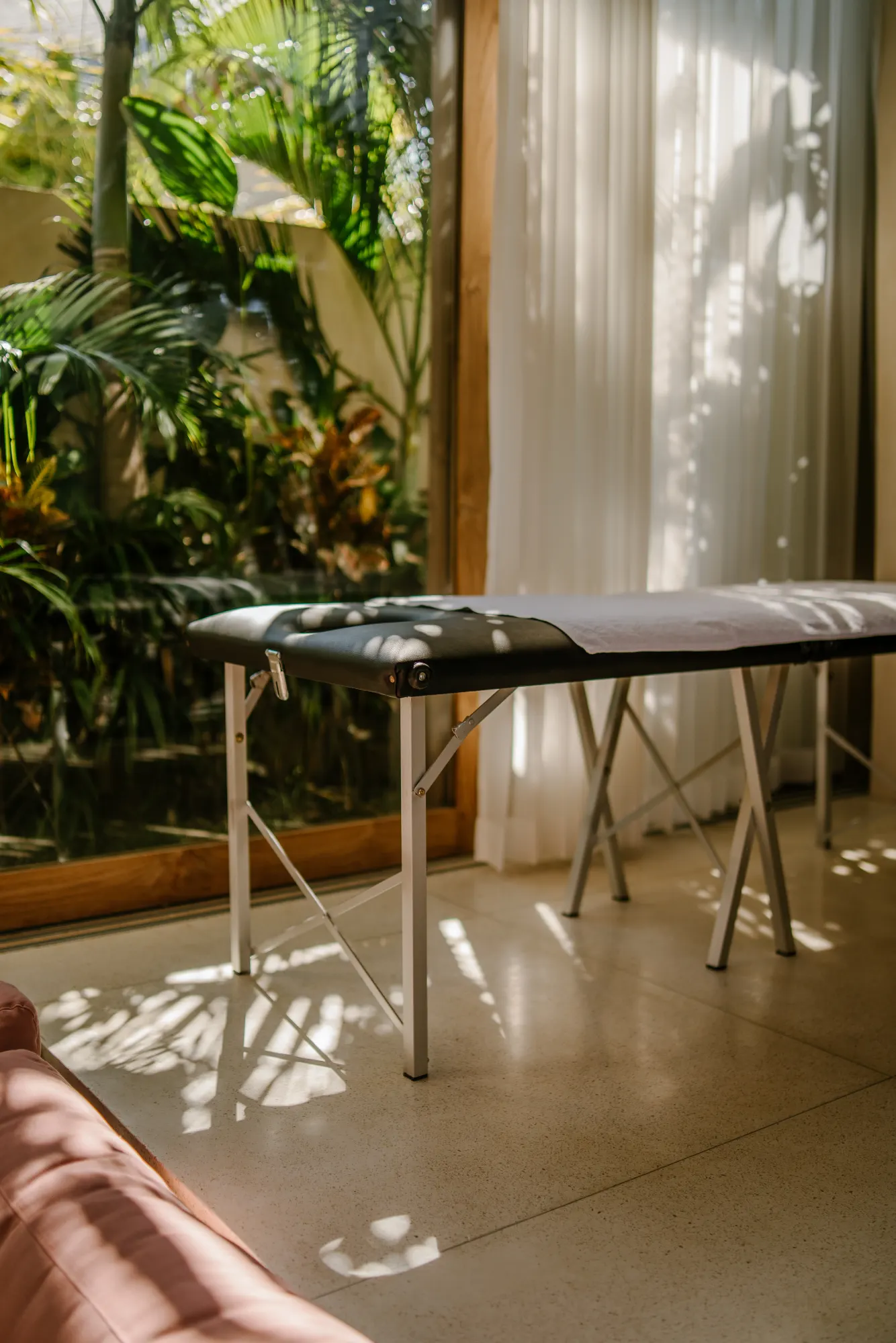 Spa massage table with tropical indoor garden setting