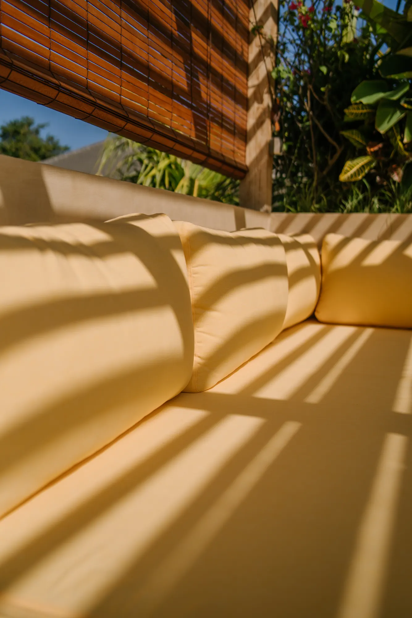 Wooden terrace with striped shade and cushions