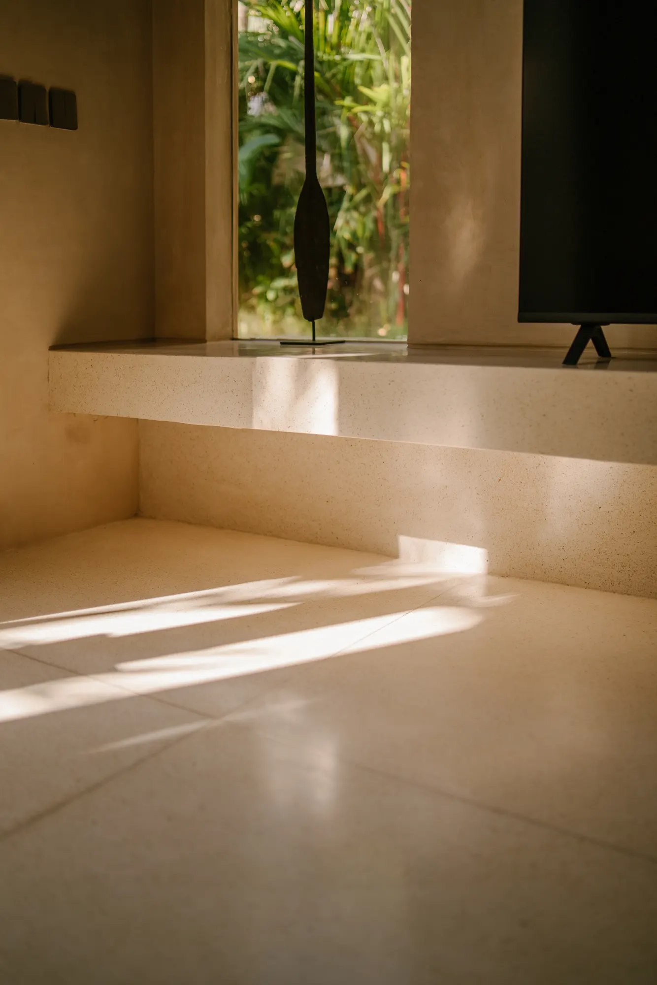 Bright bathroom with skylight and modern stone fixtures