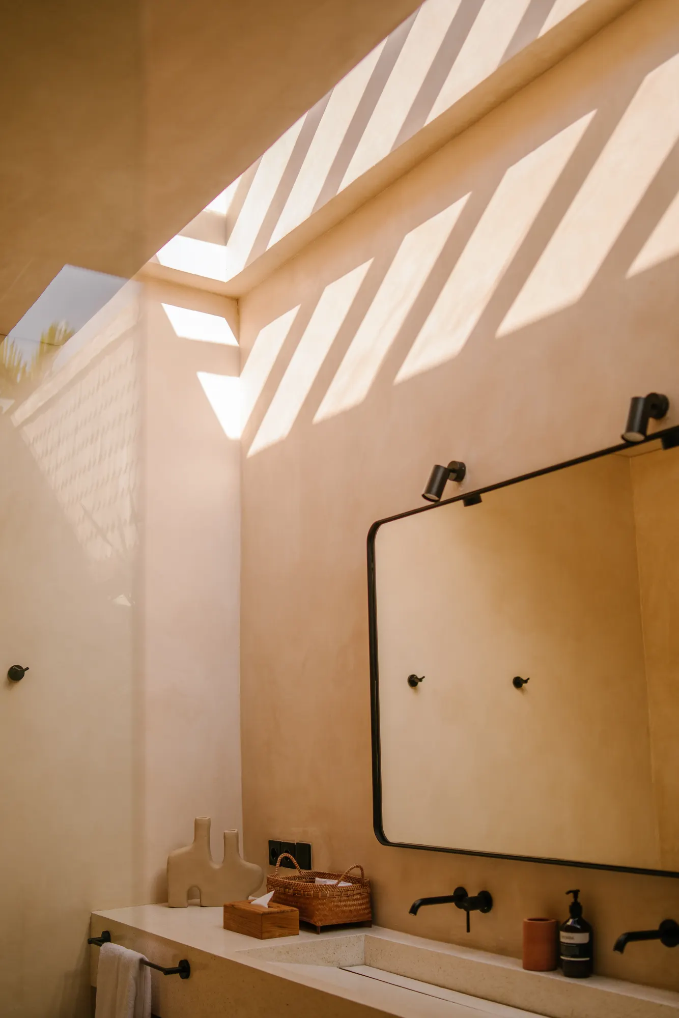 Spa-inspired bathroom vanity with natural light and mirrors