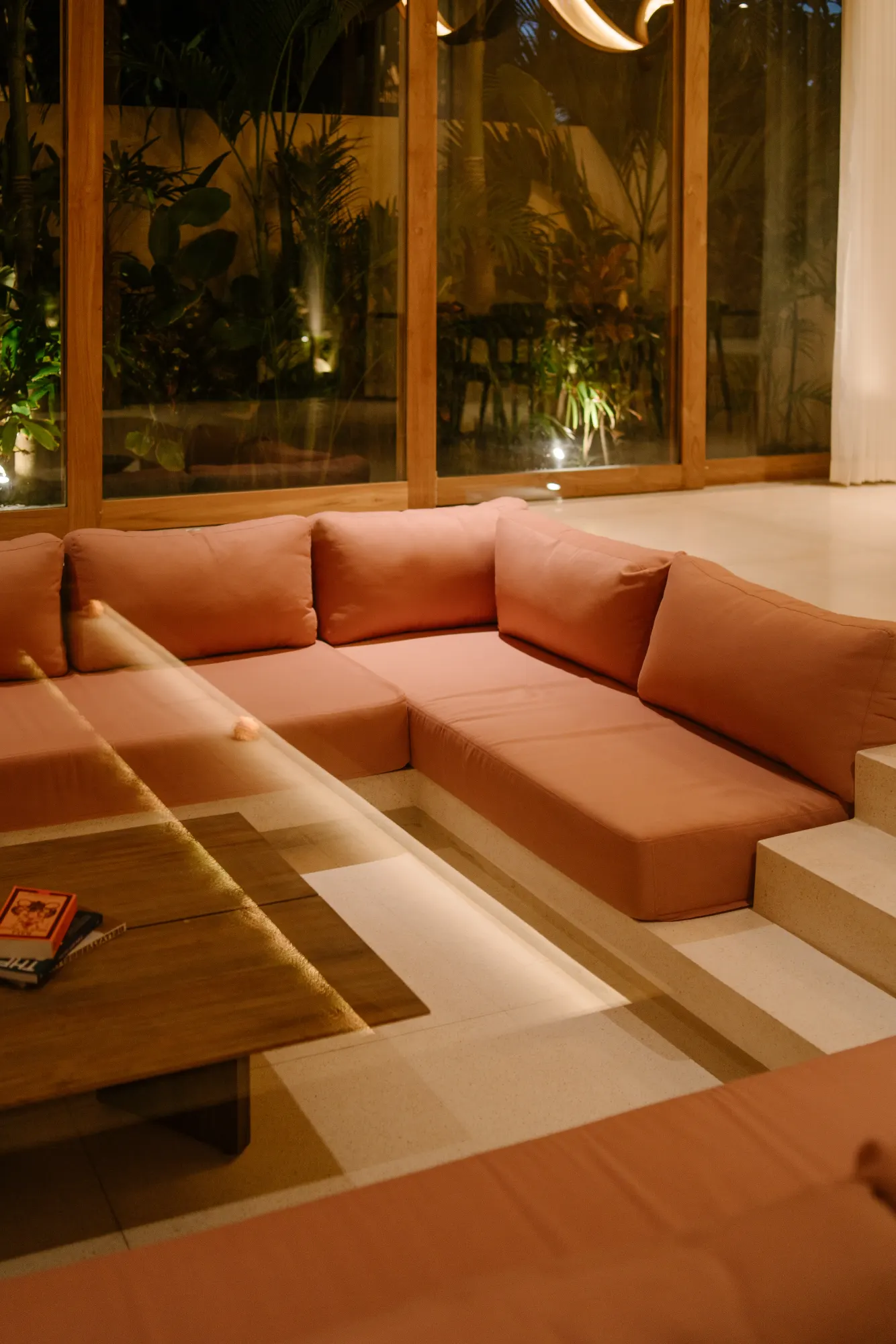 Sunken lounge with orange seating and pond