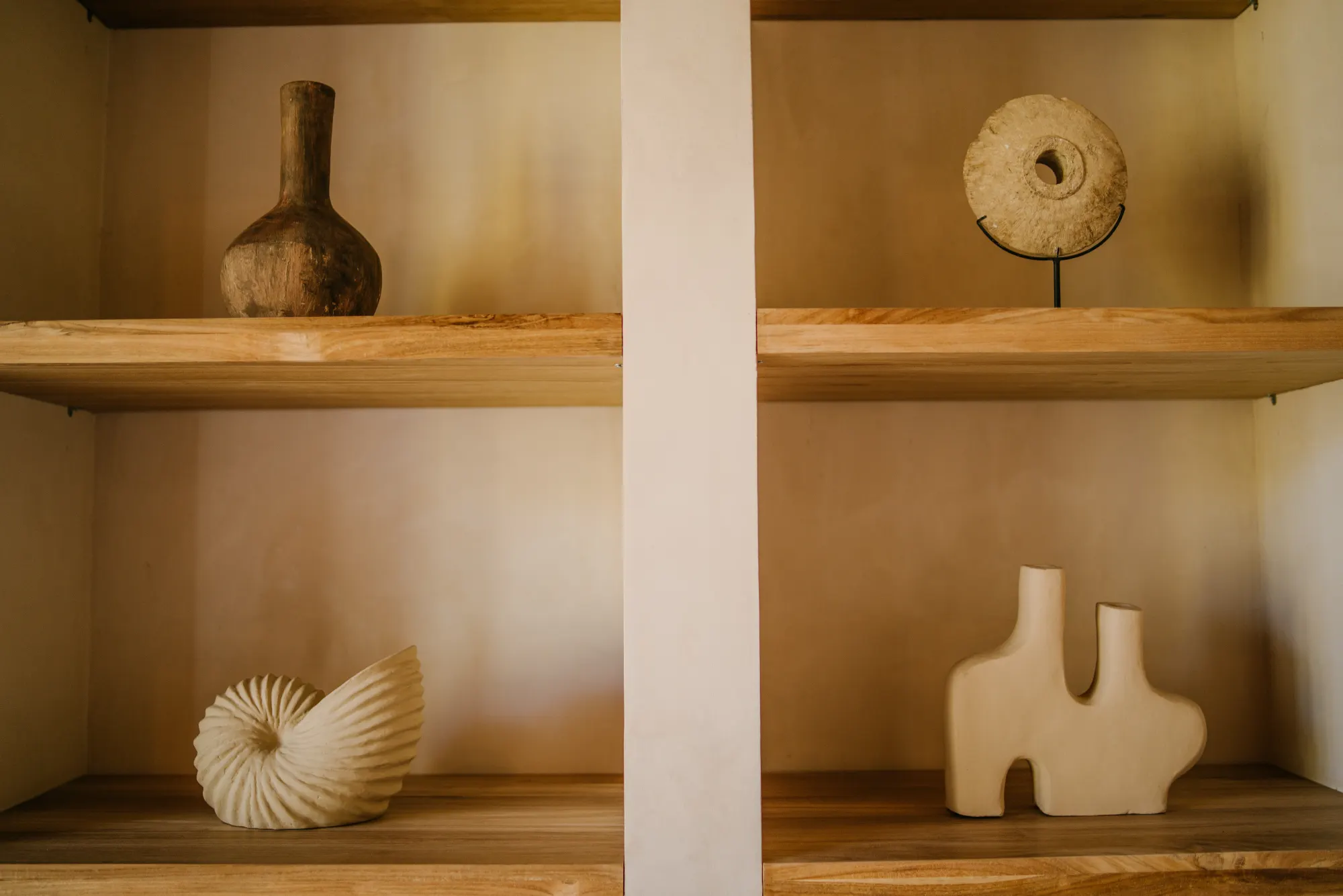 Decorative wooden vessels and art on interior shelves