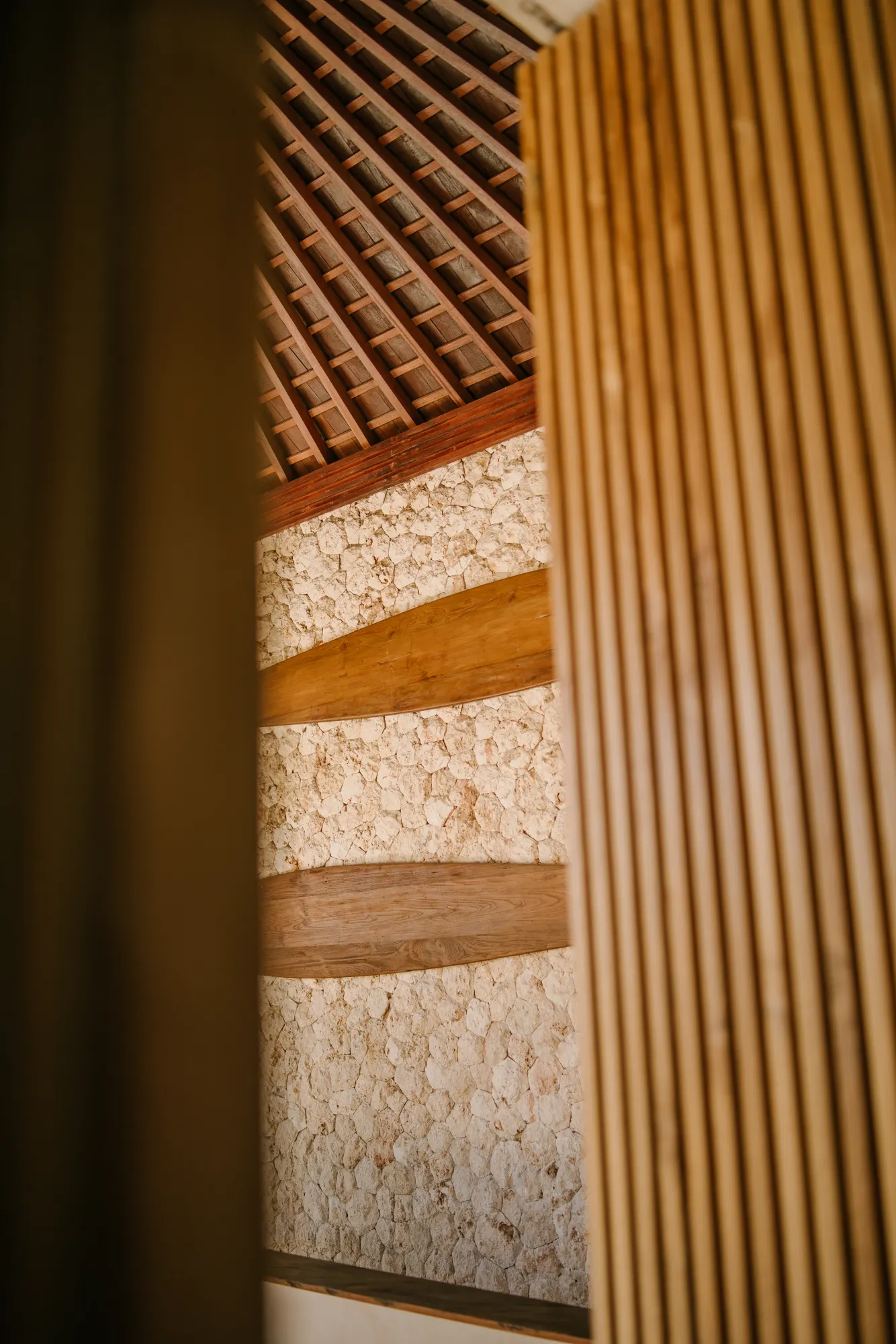 Interior detail of stairwell with patterned wall and wood