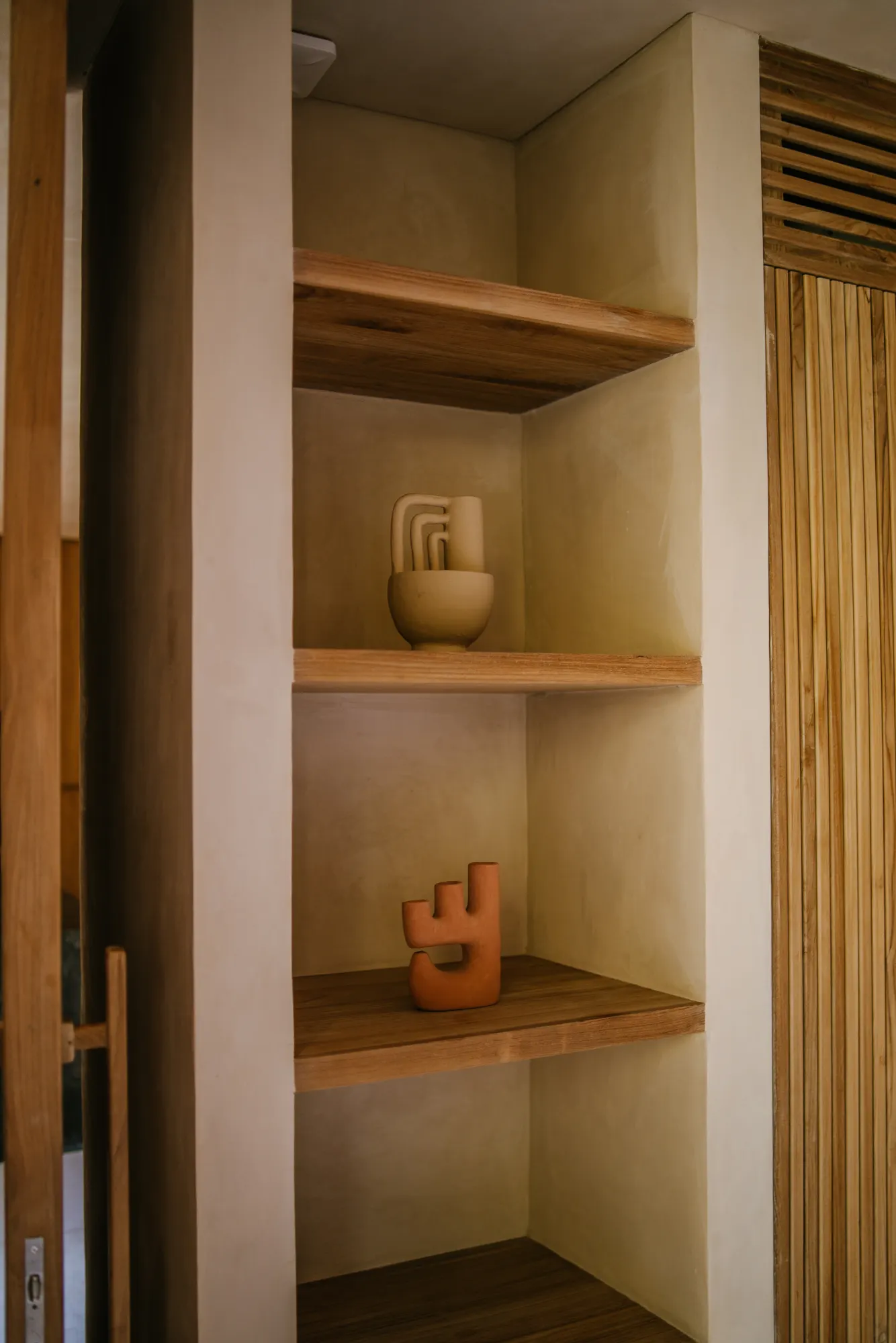 Wooden closet with shelf display of art pieces