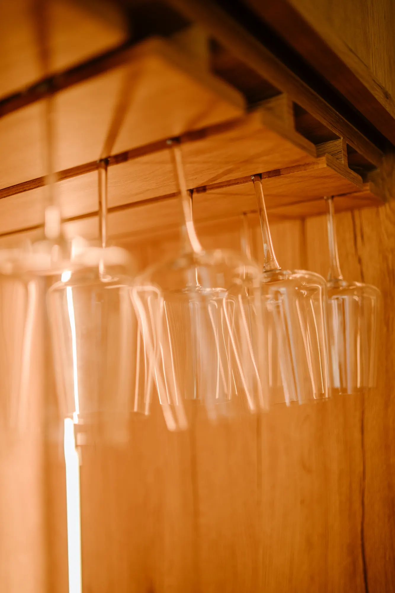 Crystal glassware hanging in home bar area