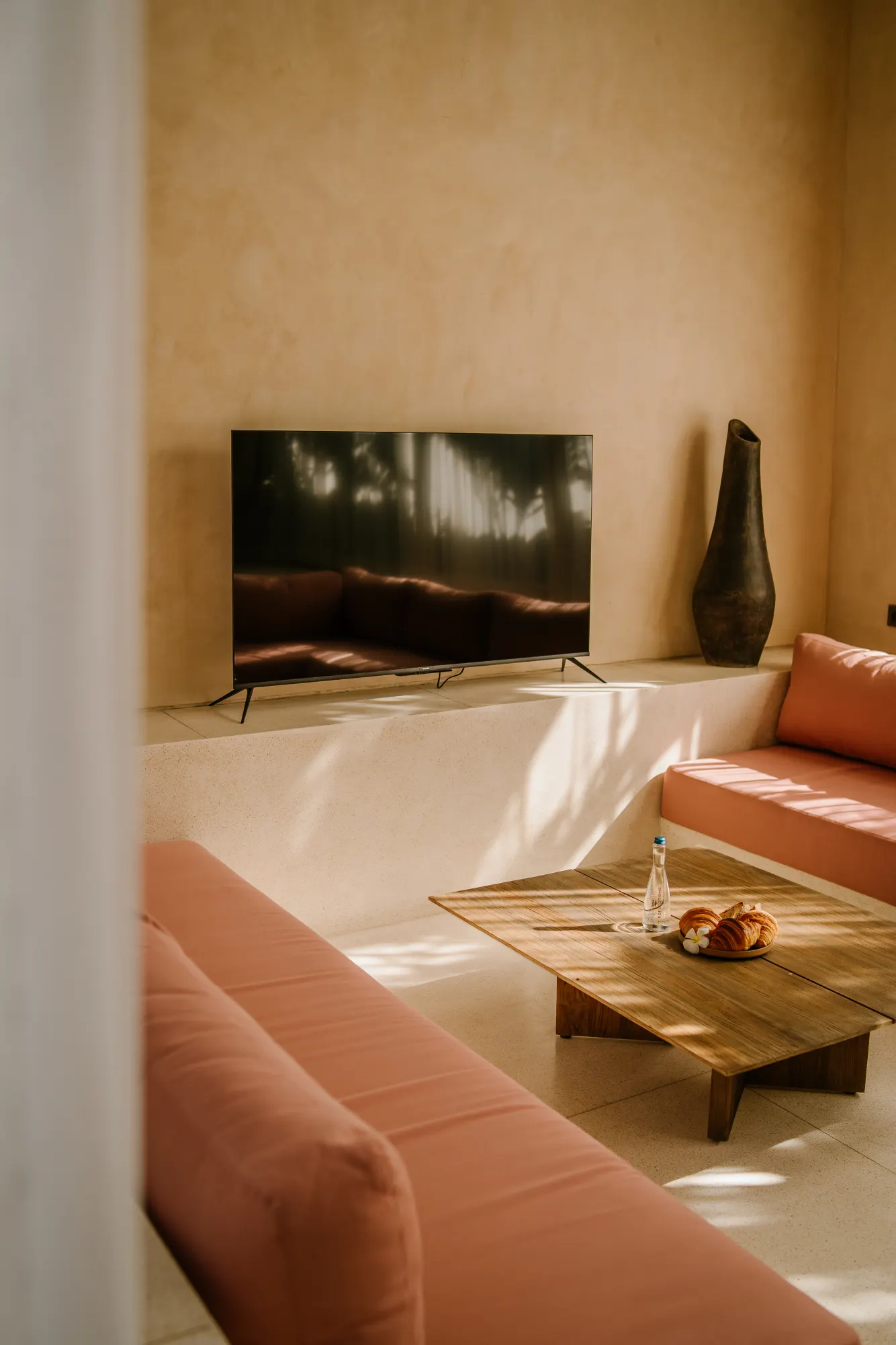 Dining and living area with curved wood architecture