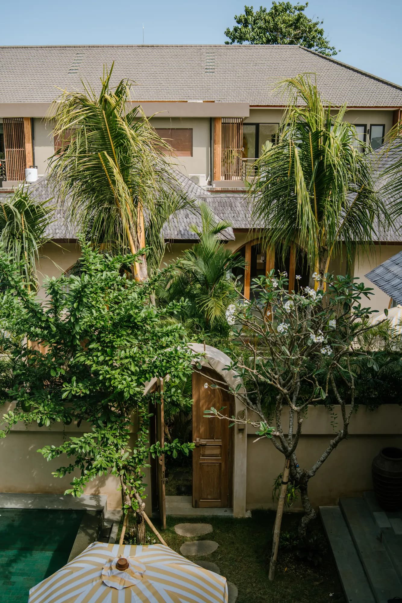 Courtyard oasis with lush tropical plants and pool