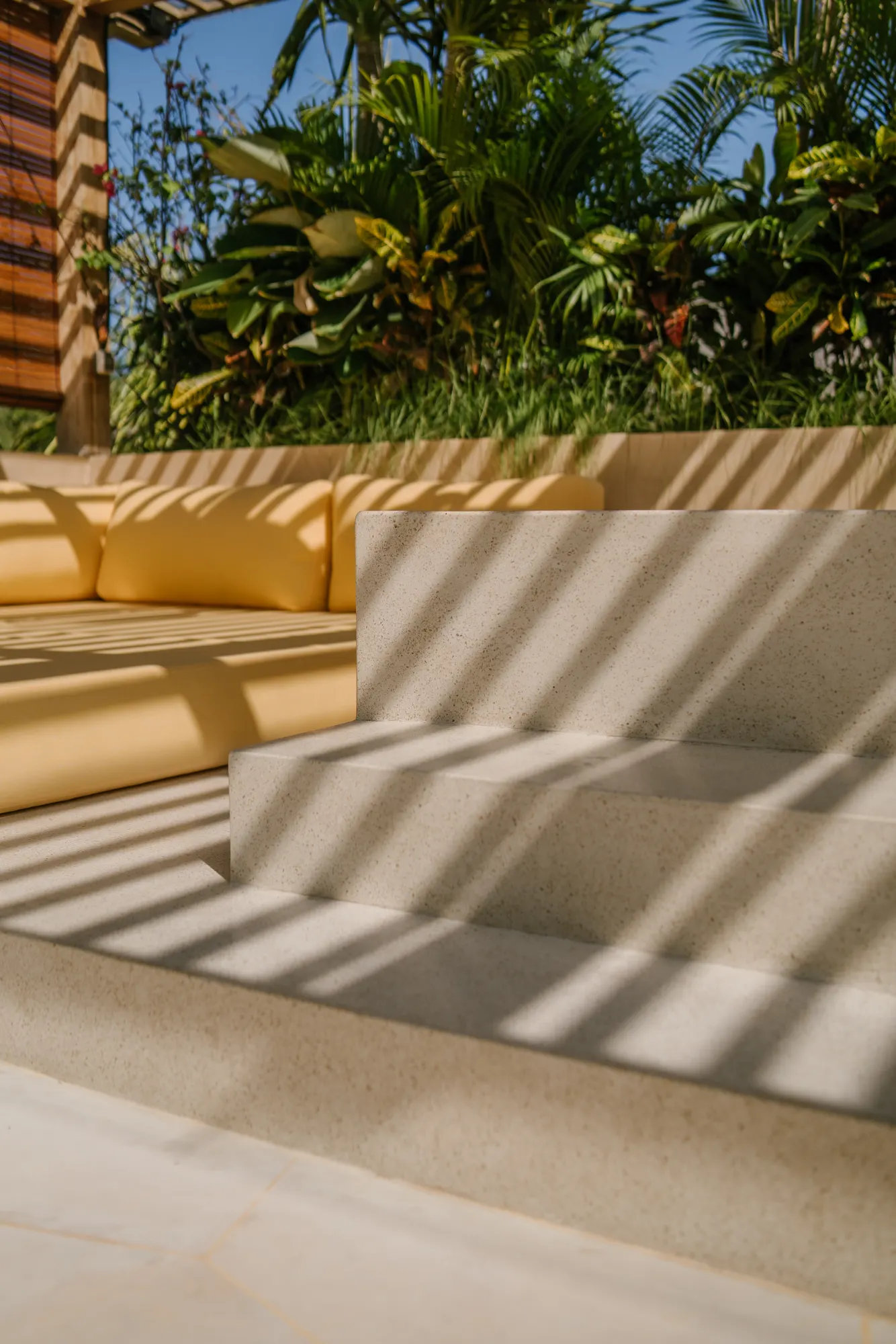 Sunny terrace with loungers and garden view