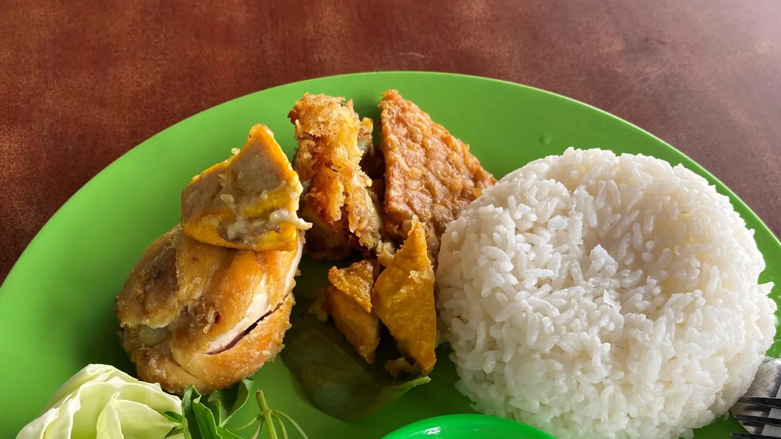 A plate of nasi campur — rice, chicken and tempeh — at a local Bingin warung